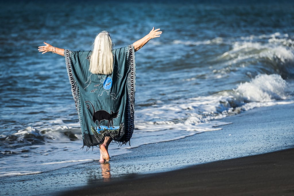 Woman walking long beach freely on an Isle of Wight Retreat